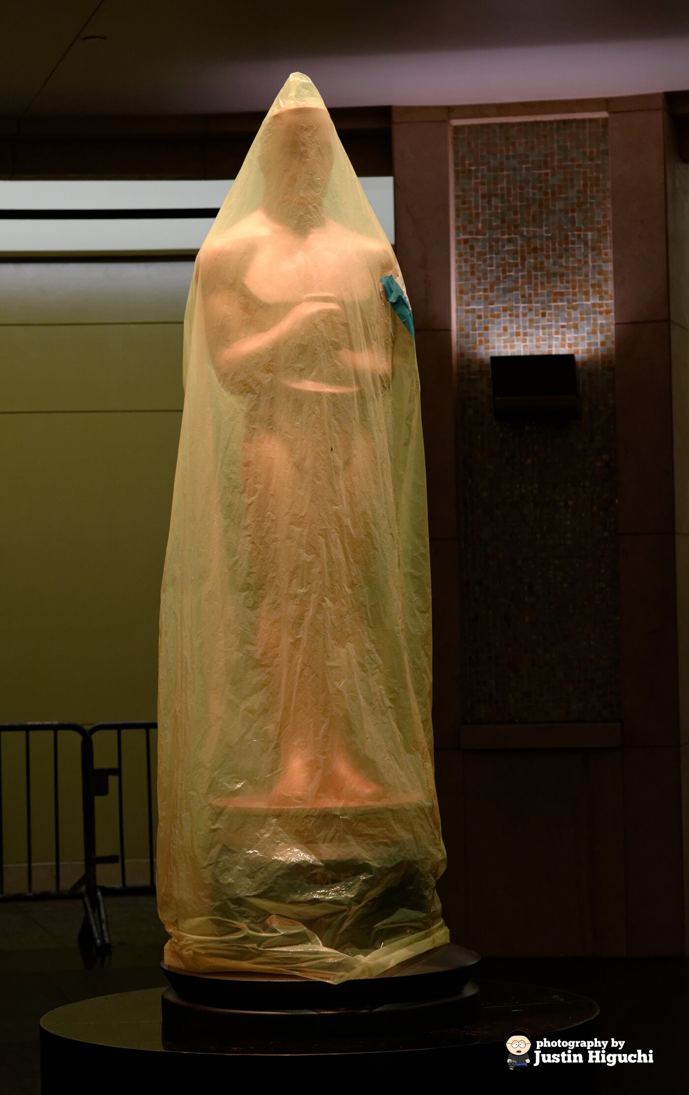 A covered Academy Award of Merit statuette stands outside the Dolby Theatre during preparations for the 2014 ceremony.