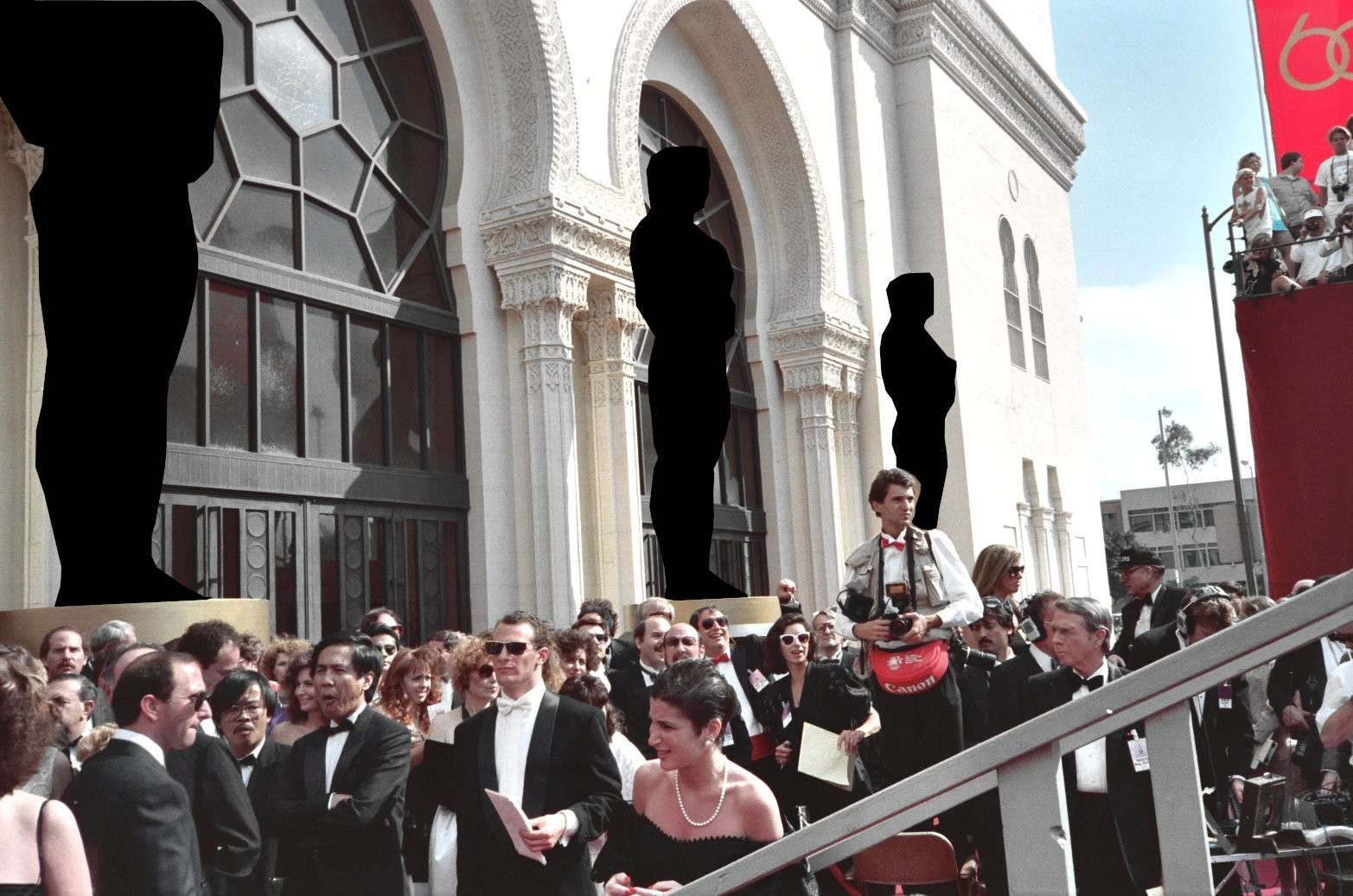 Guests and photographers crowd the red carpet at the 1988 Academy Awards outside the Shrine Auditorium.