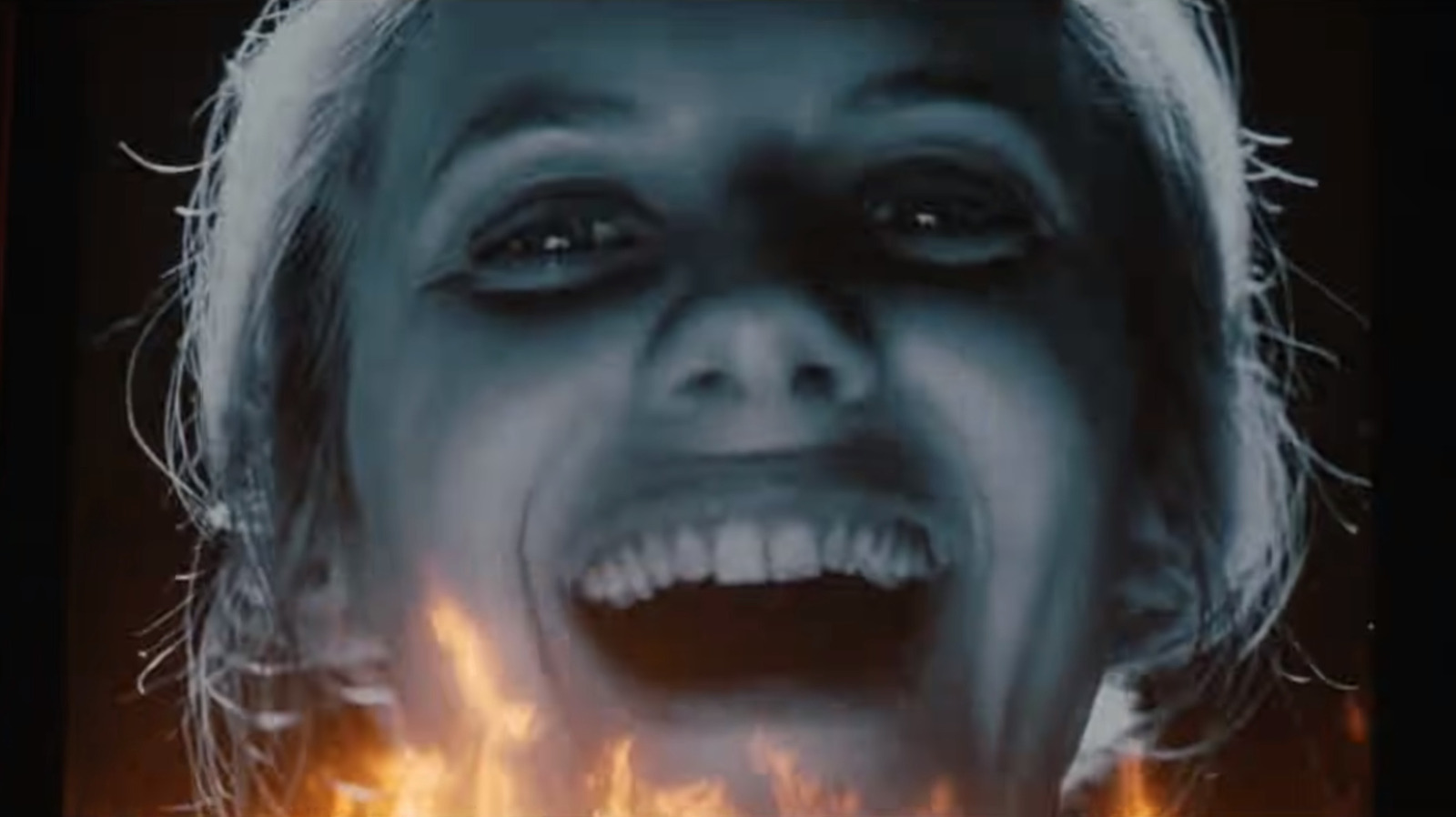 Shosanna's projected black-and-white face appears above flames during the cinema climax of Inglourious Basterds.