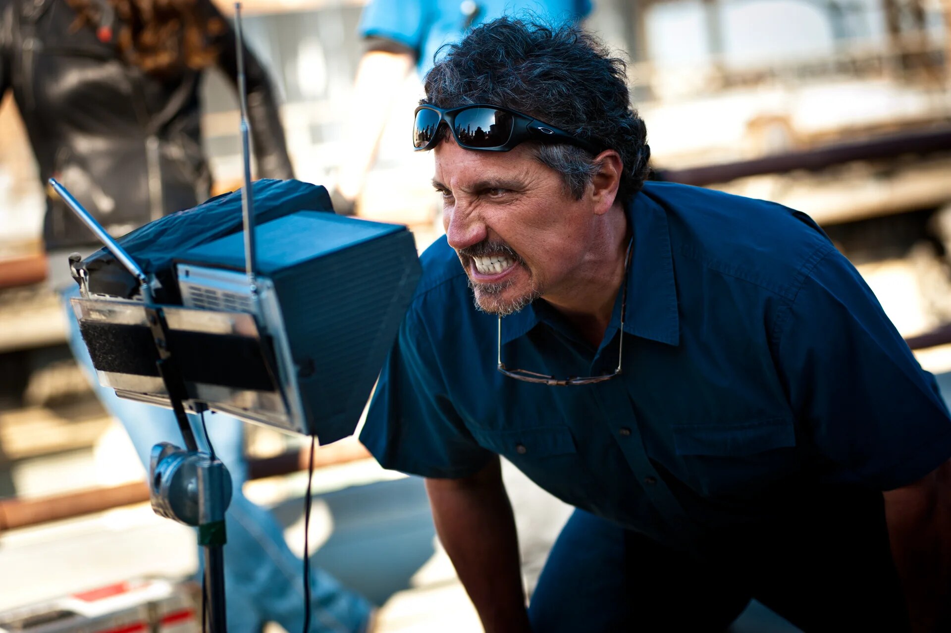 Director Rob Bowman watches a monitor while filming a rooftop fight scene for the television series Castle.
