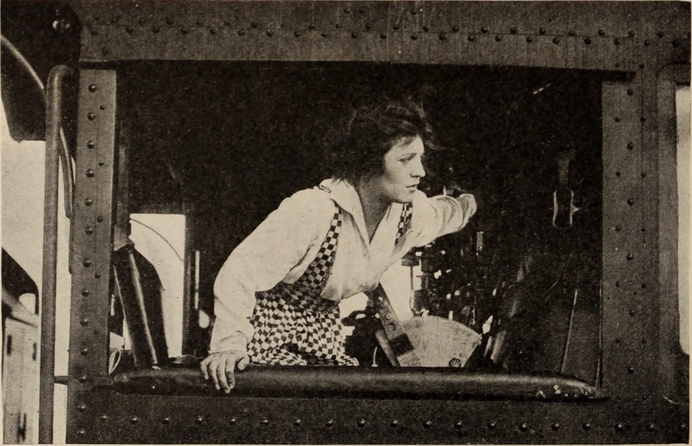Helen Holmes leans from the open side of a locomotive cab in a 1916 railroad-magazine photograph.