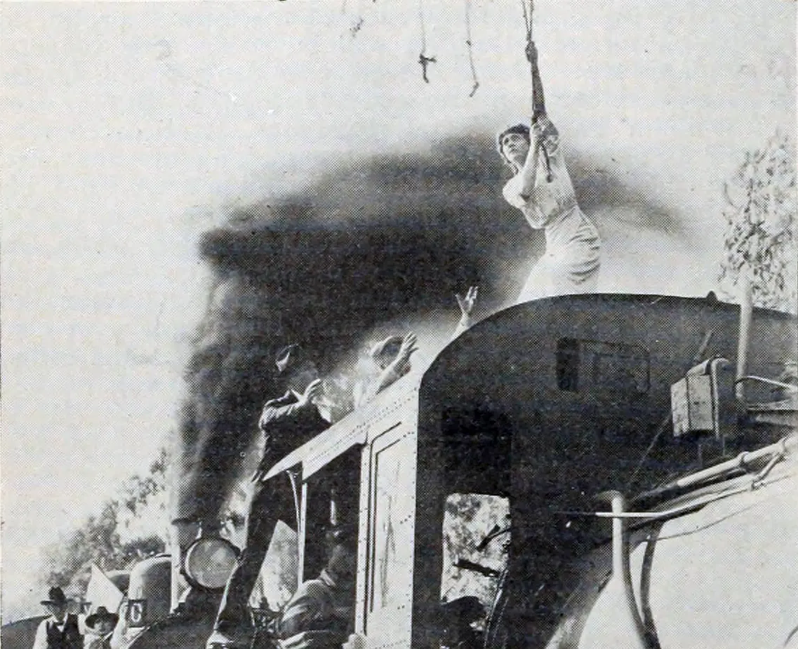 Helen Gibson stands on the roof of a steam locomotive in a 1916 image for The Hazards of Helen episode To Save the Road.