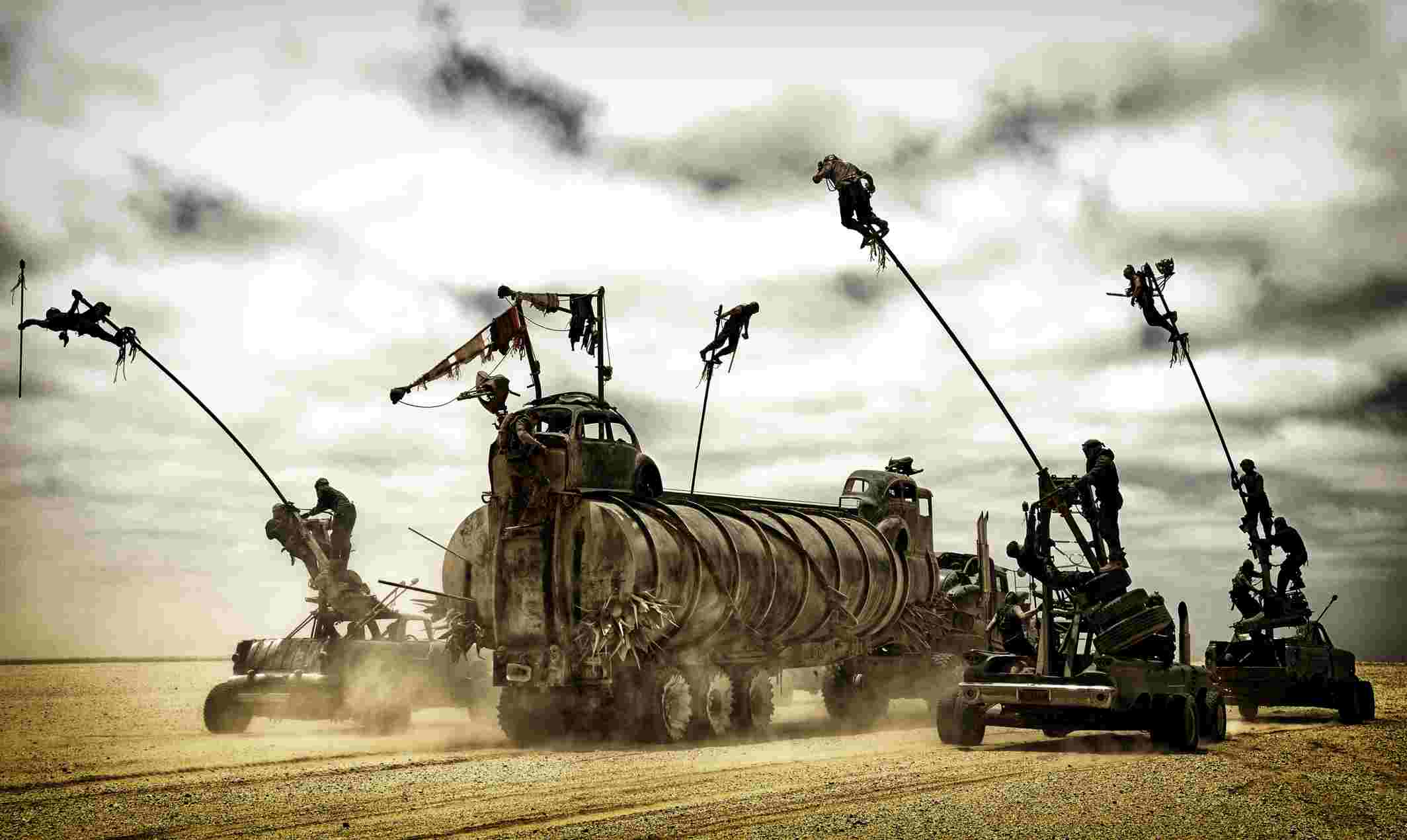 Five Polecat stunt performers swing from long flexible poles around the moving War Rig in Mad Max: Fury Road.