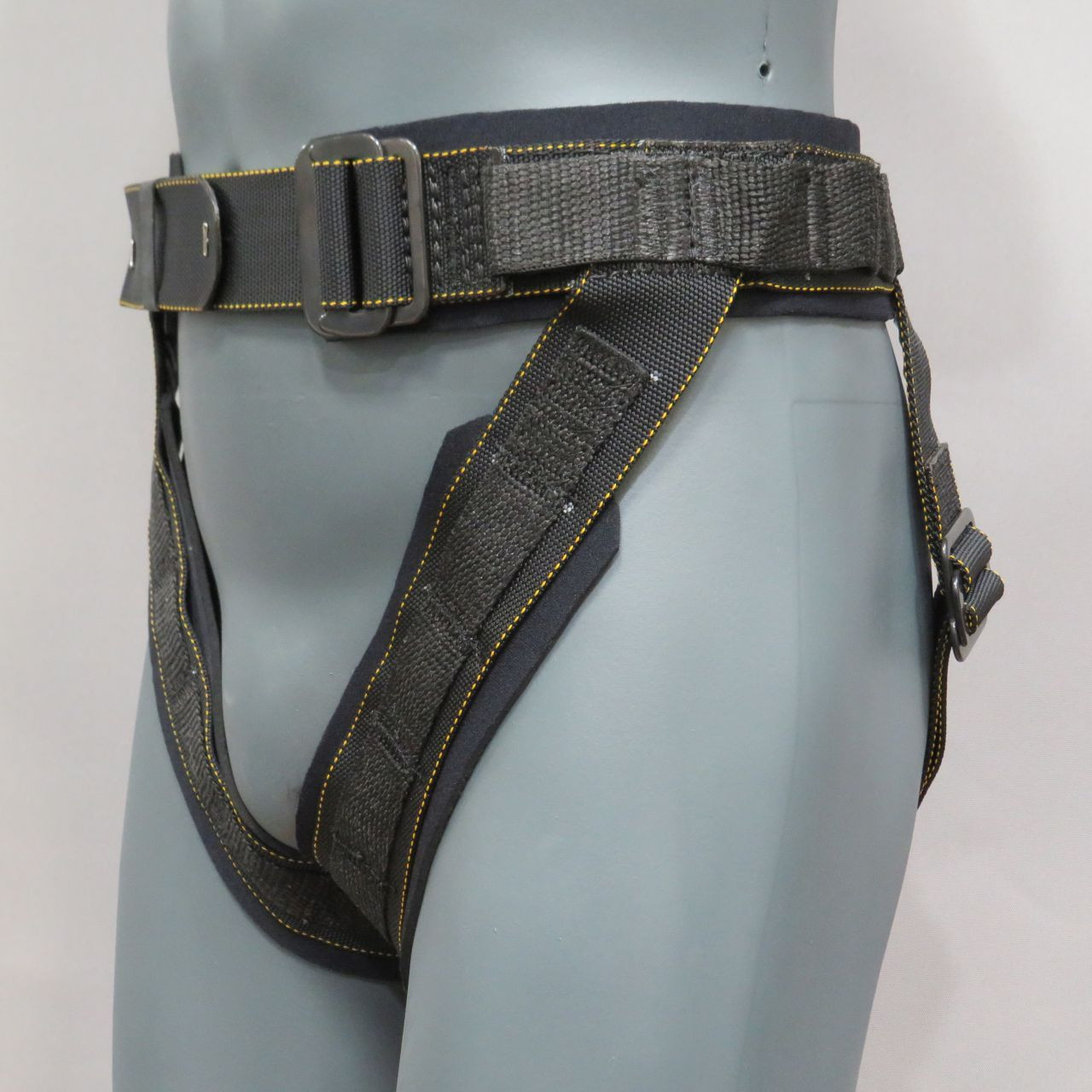 A compact black waist harness with reinforced loops and side pick points, sold for martial-arts and wirework applications.